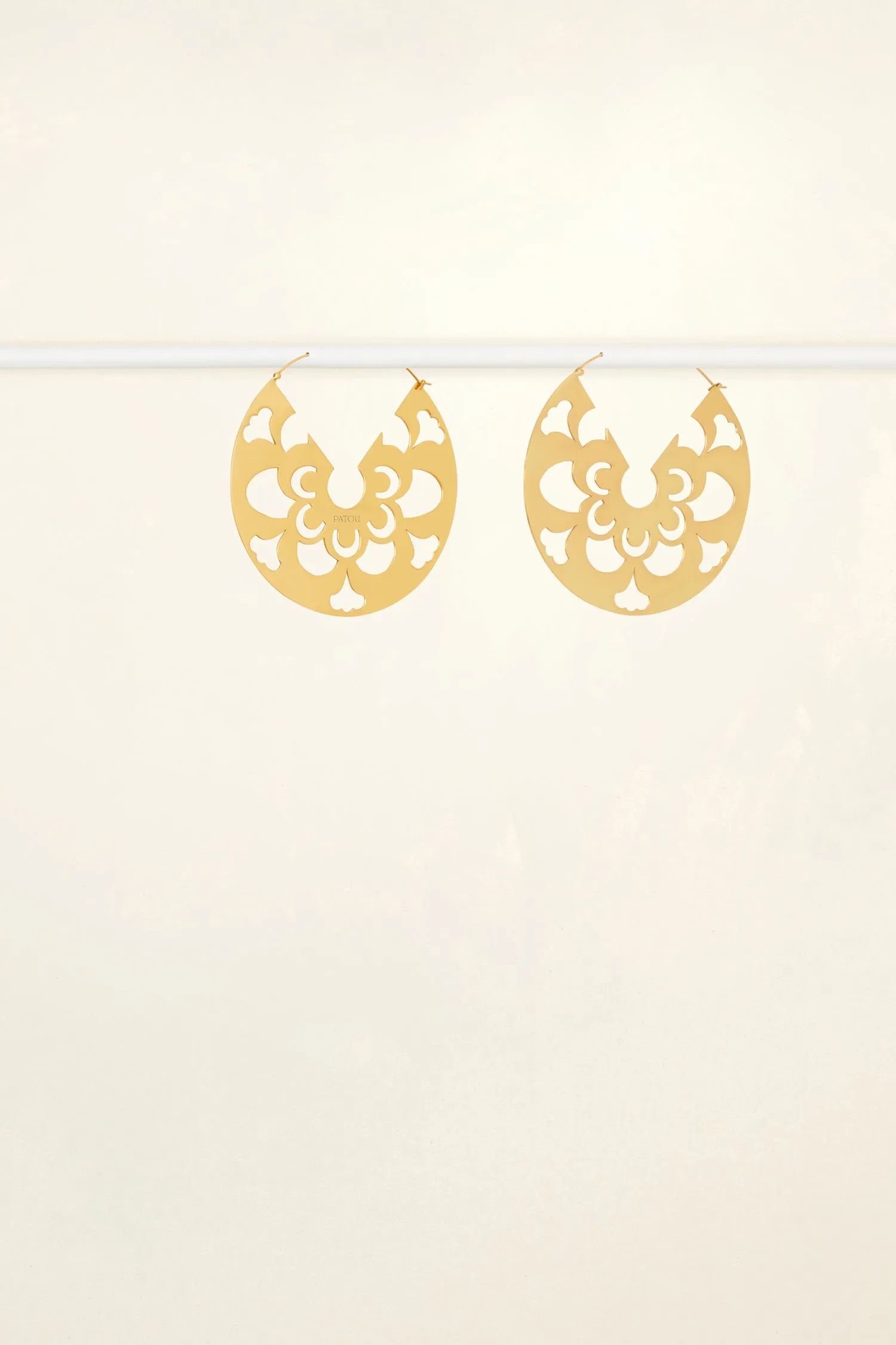 Large cut-out hoop earrings in gold-plated brass